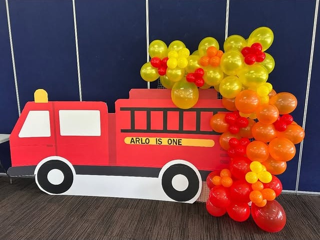 Fire truck birthday backdrop with red, orange and yellow balloons