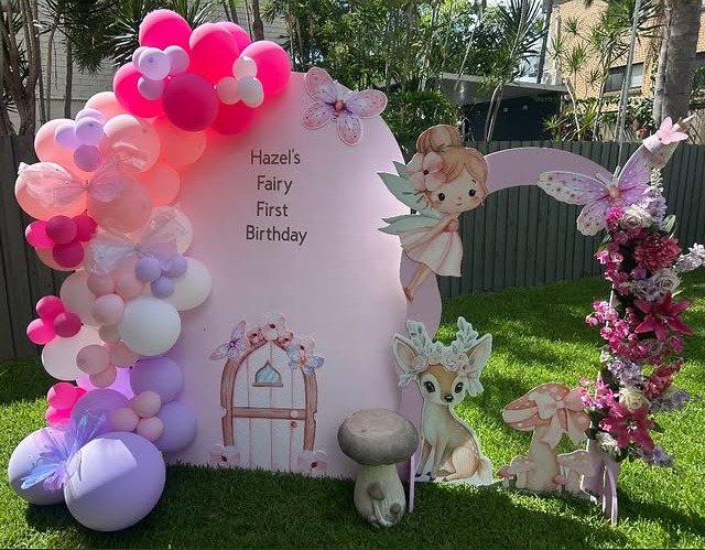 Fairy first birthday backdrop with pink balloons and woodland characters