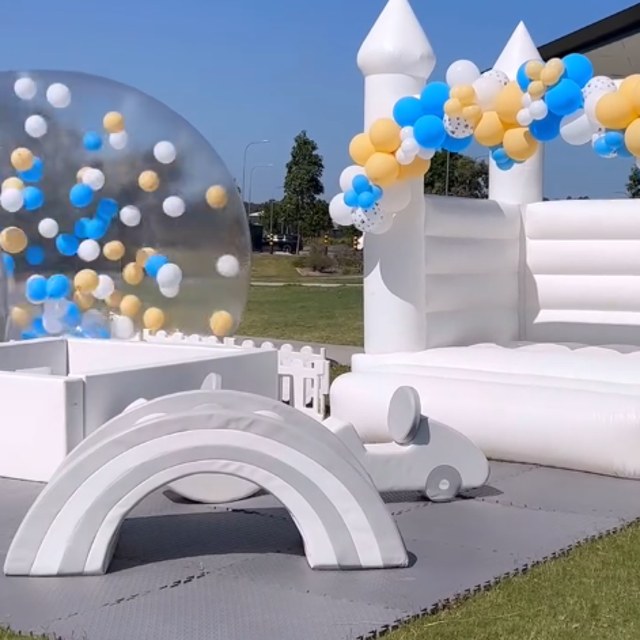 The Bubba Club’s white party setup with bubble house, castle bounce house, soft play and balloons